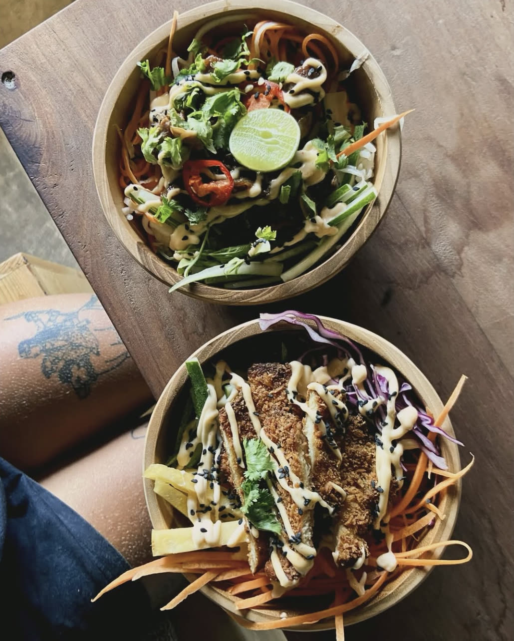 Two poke bowls with veggies and katsu